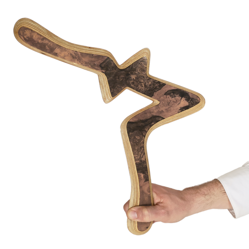 Image of Alva Size Comparison, Hand holding decorative burl wood boomerang with green and amber tones against navy blue backdrop