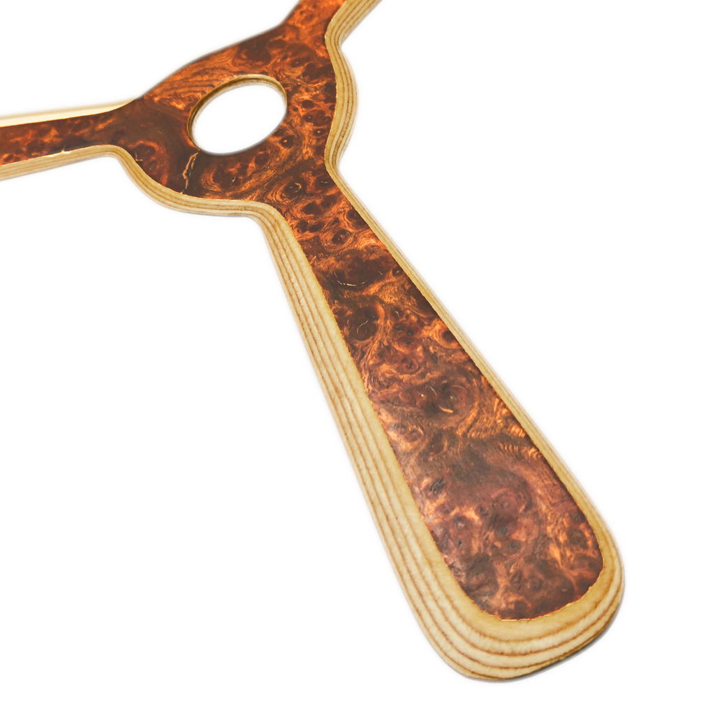 Image of Navigator Boomerang Close-up shot of walnut boomerang with center hub showing rich chocolate wood grain and laminated construction