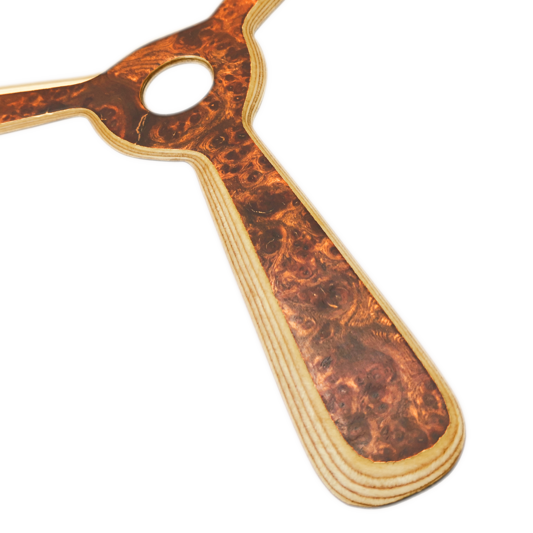 Image of Navigator Boomerang Close-up shot of walnut boomerang with center hub showing rich chocolate wood grain and laminated construction