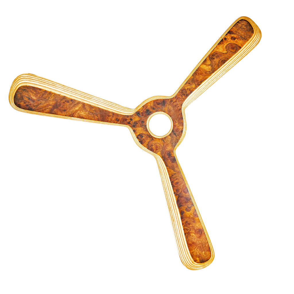 Image of Navigator Boomerang dynamic shot with center hole and golden swirl patterns on laminated edges