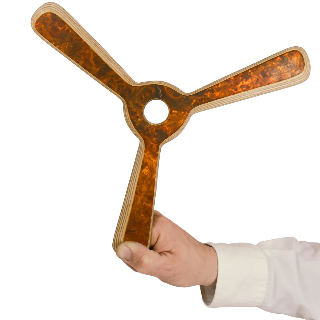 Image of Navigator Boomerang size comparism shot with dark walnut tri-blade having  circular center cutout and plywood edges