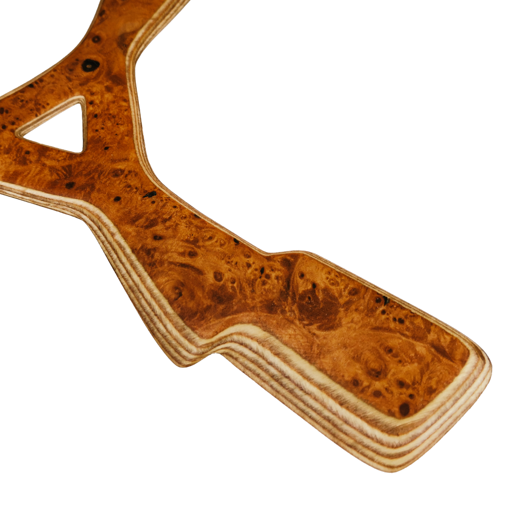 Image of Zeus Close-up with Karelian birch burl boomerang center showing distinctive bird's eye grain and triangular cutout