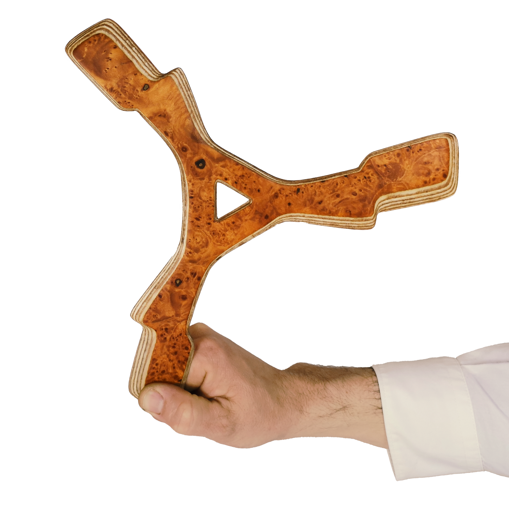 Image of Zeus Boomerang size comparison Hand holding Y-shaped Karelian birch burl boomerang showing rich amber wood patterns and plywood edges